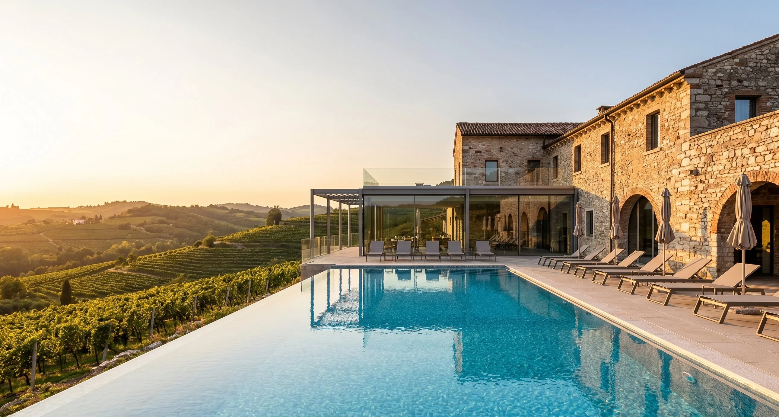 Luxury wine resort with infinity pool overlooking Valpolicella valley at sunset